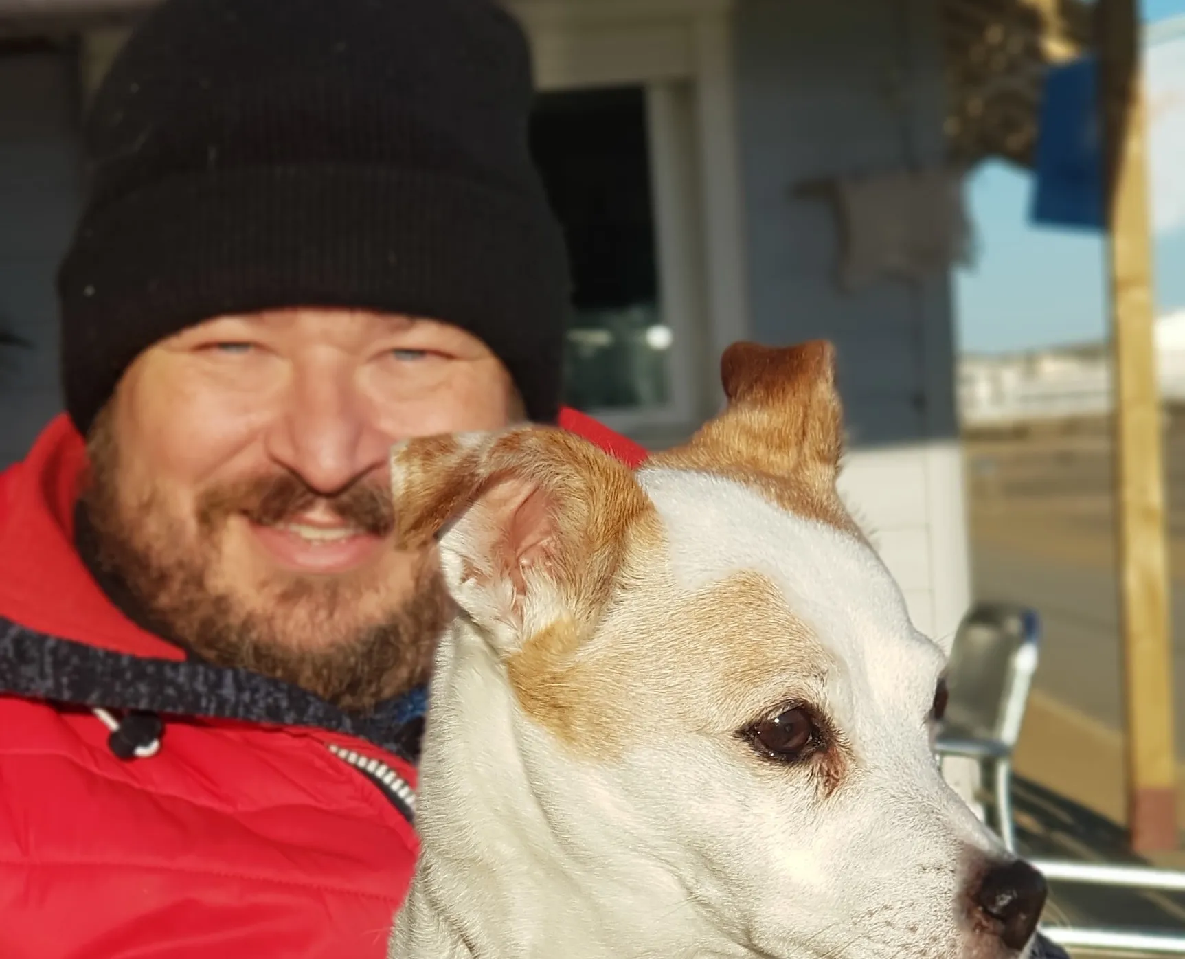 Kerry Jefferies with his dog, in the sun.